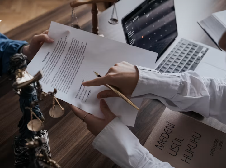 Lawyer and client reviewing a legal document at a desk with scales of justice